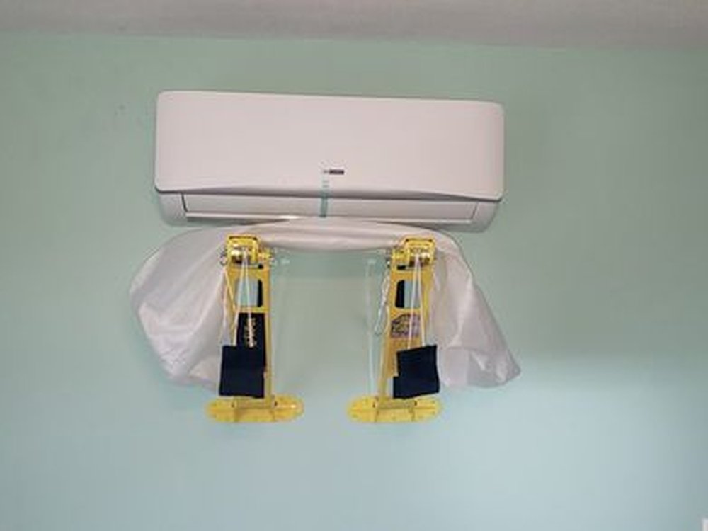 Ductless mini-split indoor unit mounted on a wall mid-install